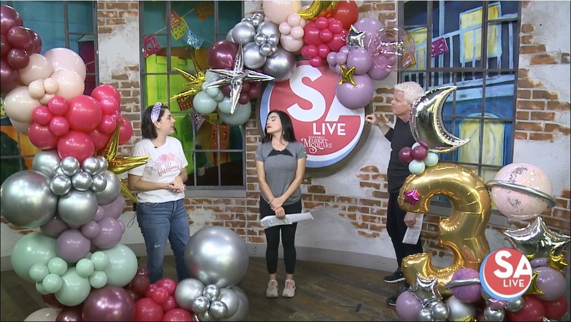 People featured on a TV show discussing balloon decor and garlands