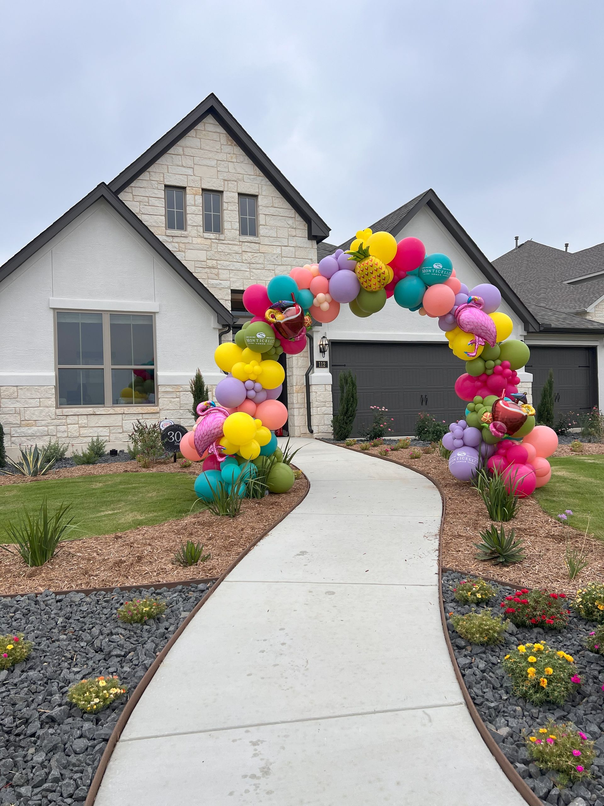 A house with a balloon arch in front of it