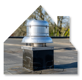 A metal roof exhaust vent mounted on a square black curb on a flat rooftop against a background of trees.
