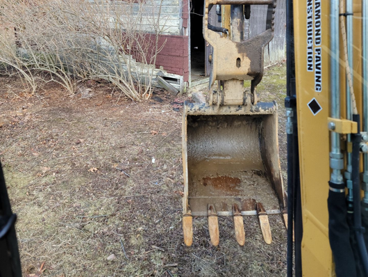 Heavy excavating machinery digging and preparing the ground for a paving project