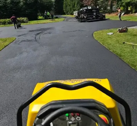 Heavy-duty milling equipment removing worn asphalt layer during road rehabilitation project