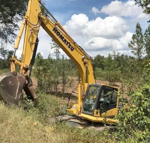 Expert land clearing and excavation crew working with equipment to ready the land for development