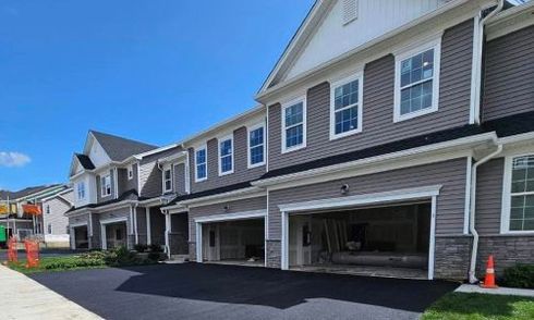 Residential asphalt driveway paving with smooth blacktop finish in front of a suburban home

