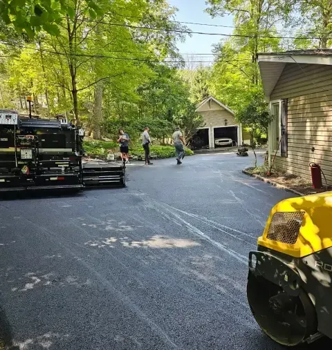 Asphalt milling machine grinding and removing old pavement to prepare surface for repaving