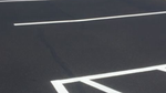 Residential asphalt driveway paving with smooth blacktop finish in front of a suburban home
