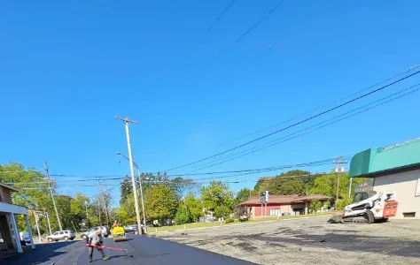 Freshly paved commercial parking lot with clear line markings and smooth asphalt surface