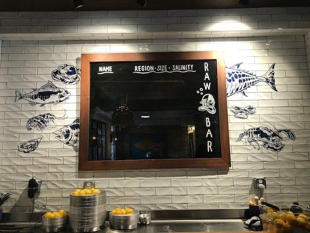 White Tiles Behind Bar Signage — Charleston, SC — Sunray Flooring Co