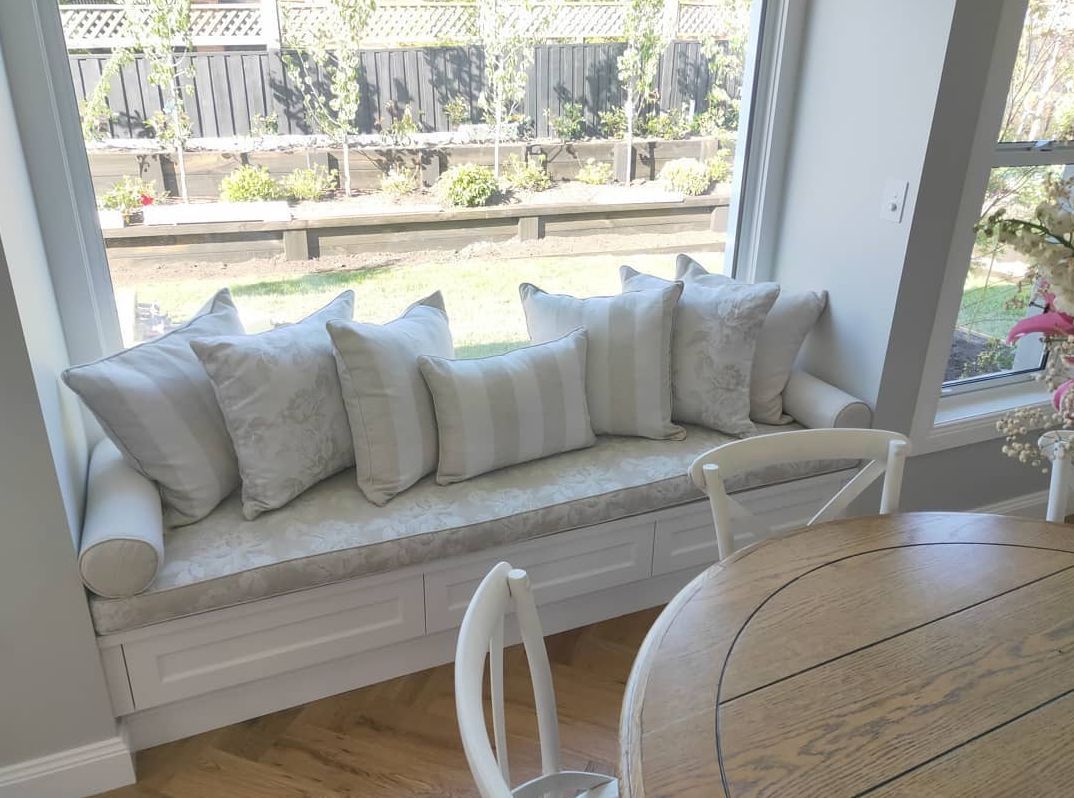 White couch, wooden table and floor - Curtains in Welby, NSW
