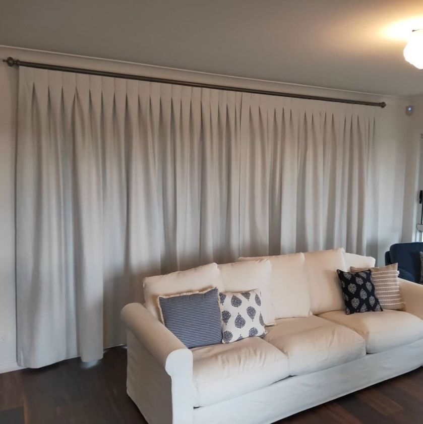 Living area with white couch - Curtains in Welby, NSW