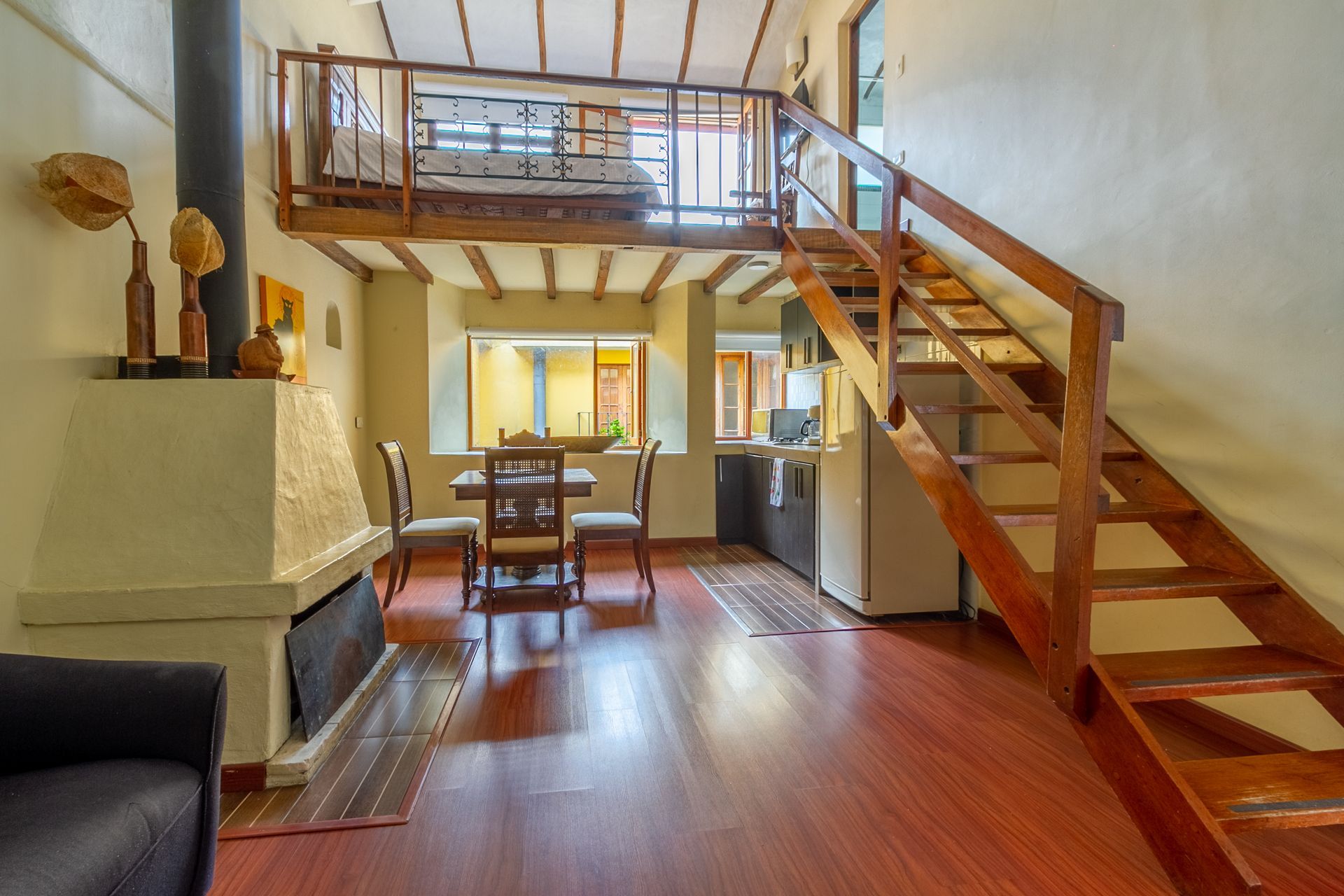 A living room with a staircase leading up to the second floor.