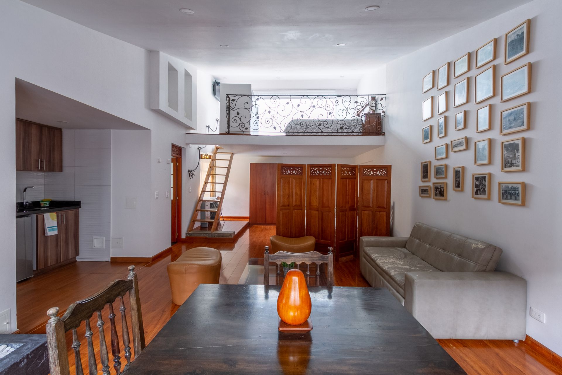 A living room with a dining table and chairs and a couch.