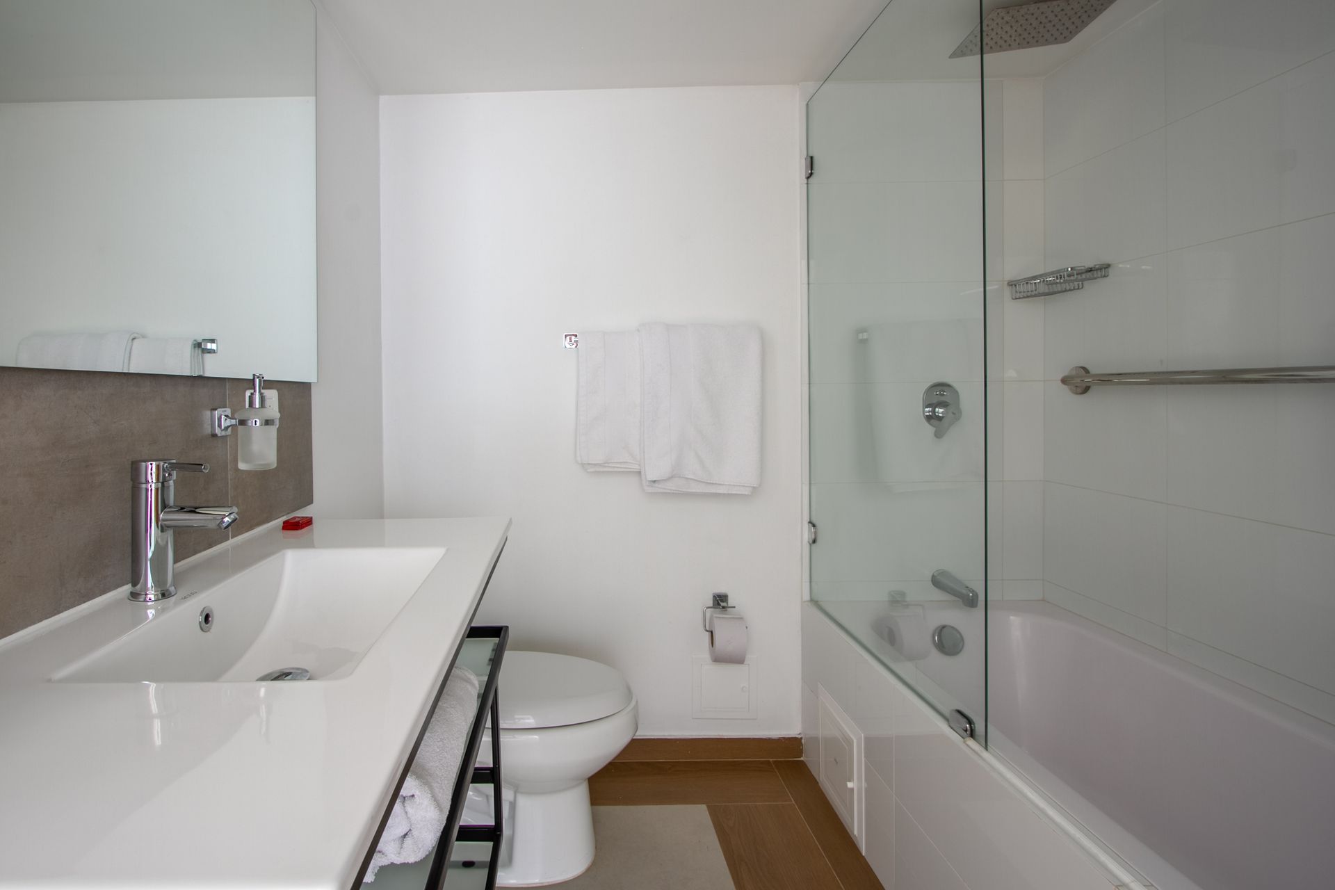 A bathroom with a toilet , sink and bathtub