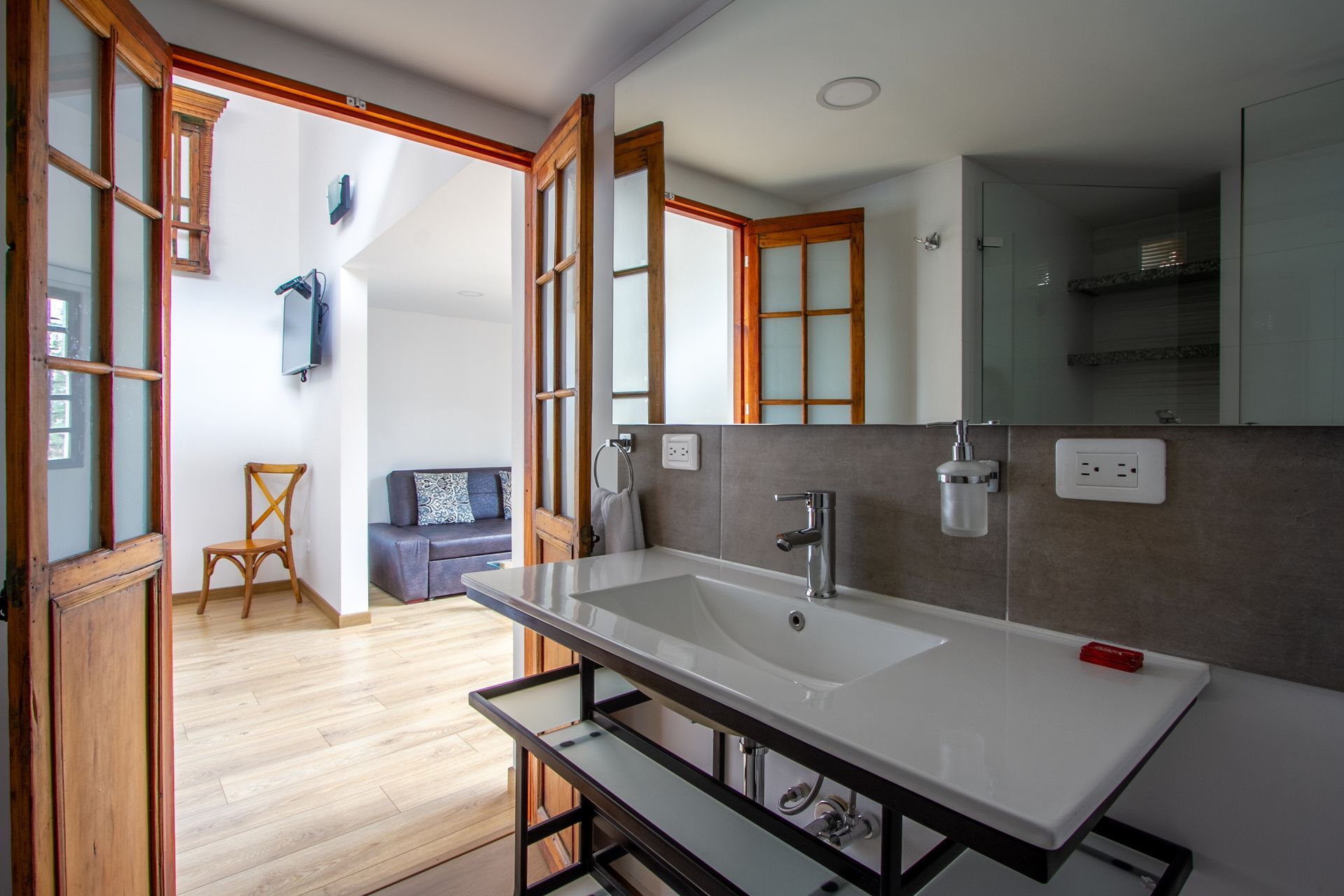A bathroom with a sink and a mirror.