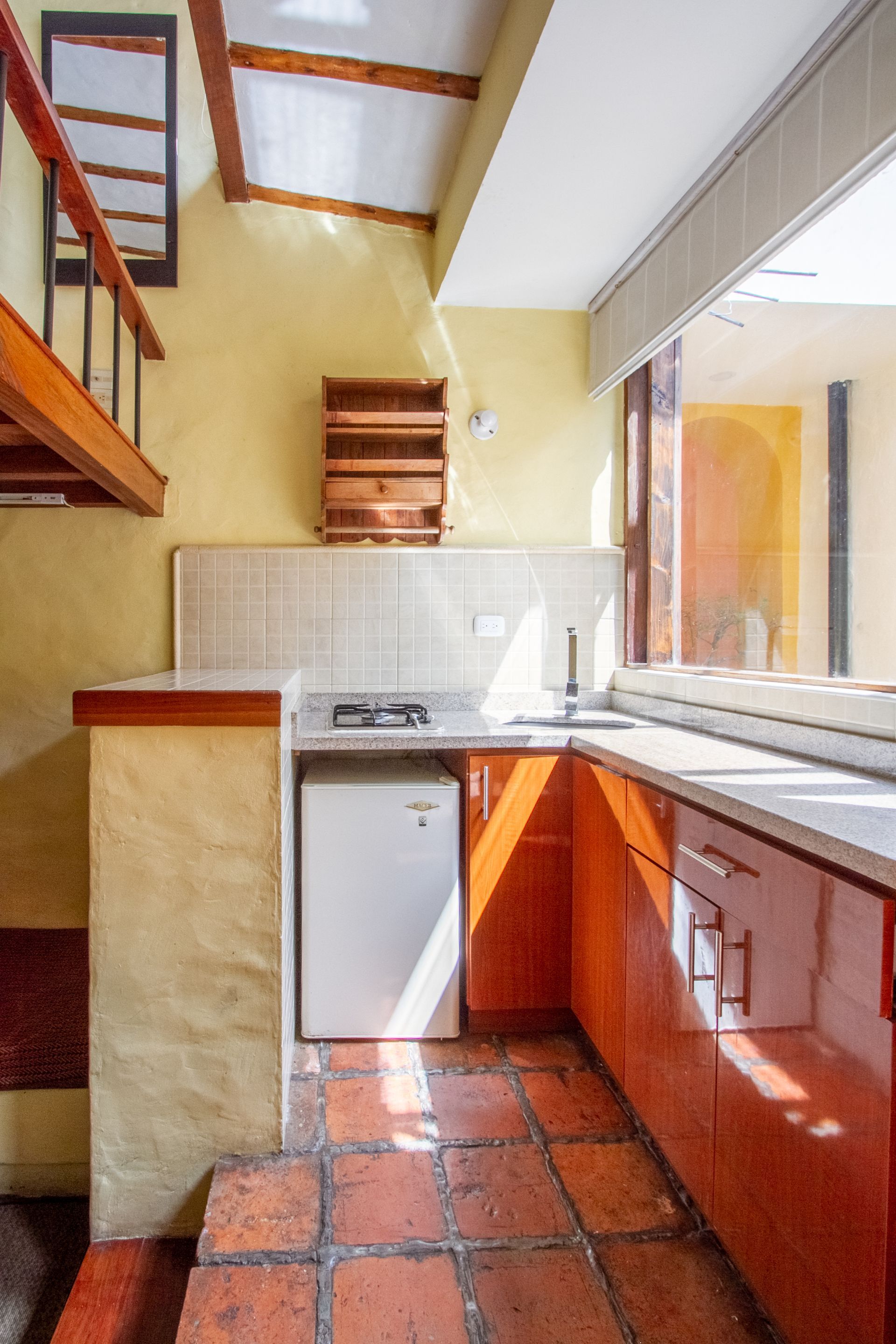 A kitchen with a stove , sink , and refrigerator.