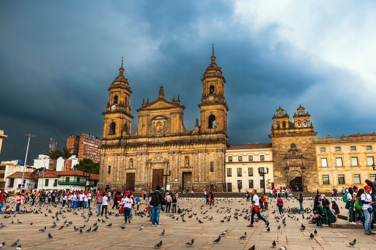 A group of people are standing in front of a large building.