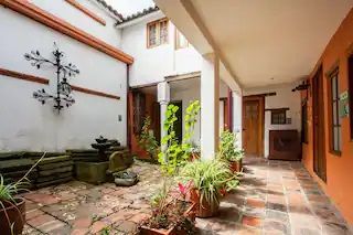 A courtyard with potted plants and a fountain in a building.