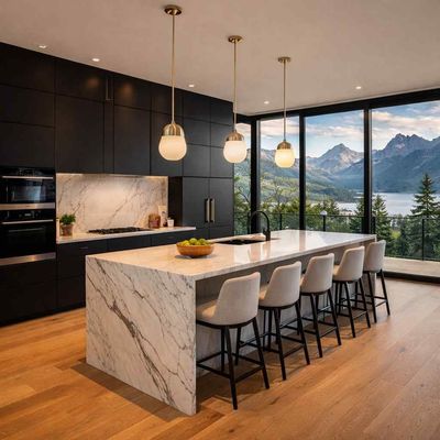 A modern kitchen with black cabinets, a marble island with four bar stools, and large windows overlooking mountains.