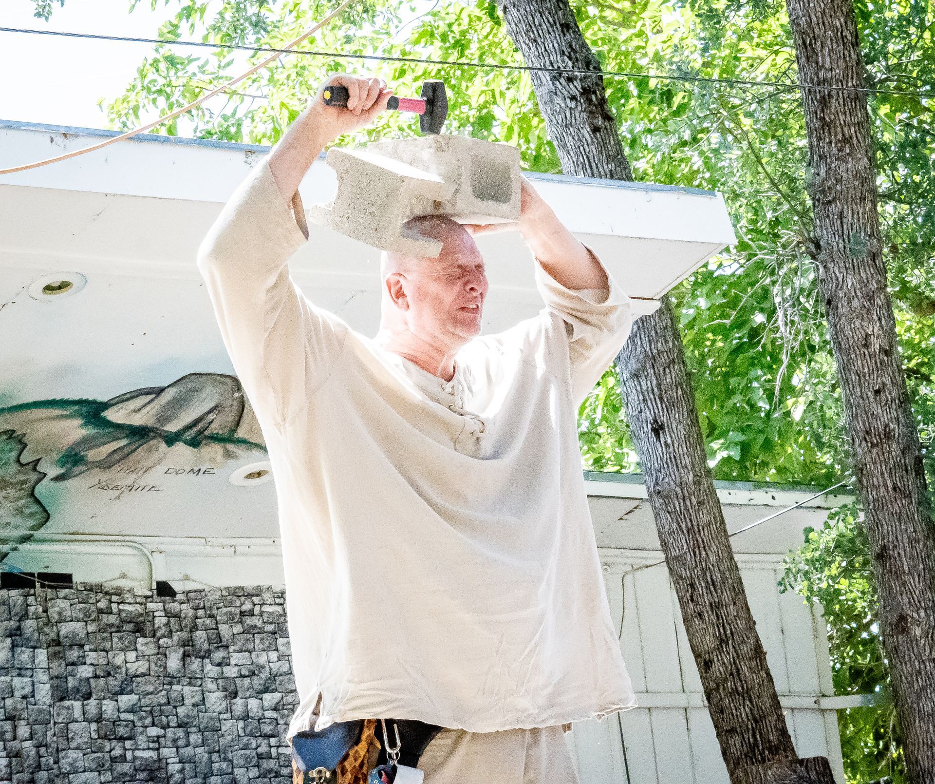 george the giant hammering a brick on his head