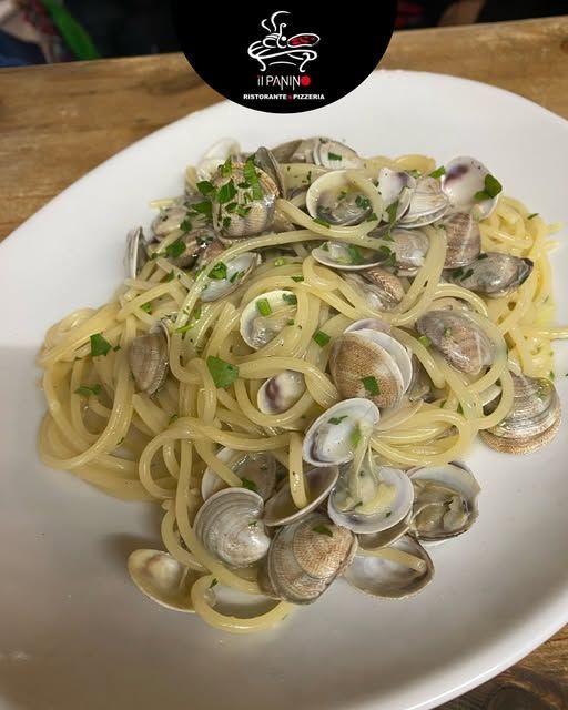 Un piatto bianco con sopra spaghetti e vongole