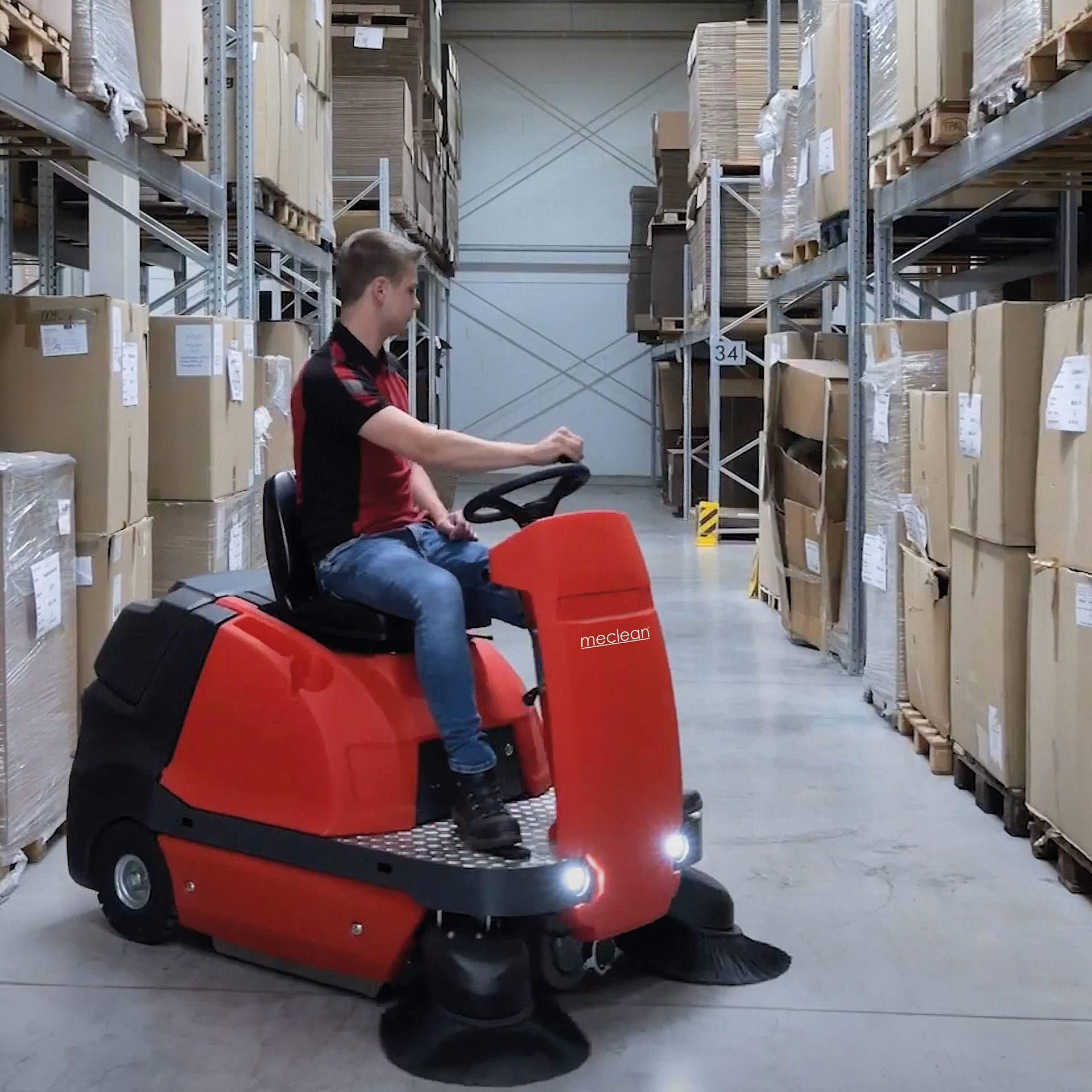 Meclean ride on sweeper BUSTER 1150 sweeping on floor in warehouse