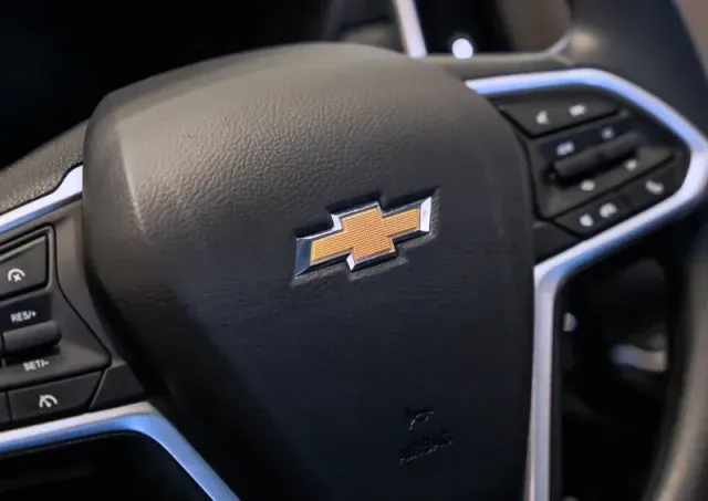 Close-up of a Chevrolet steering wheel with logo and control buttons on the spokes