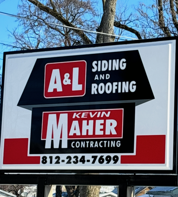 Person using power tool on house siding, outdoors. Ladder nearby.
