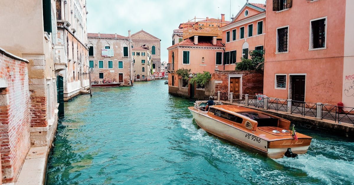 A boat is floating down a canal in venice.
