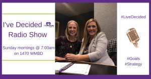 Two women are sitting at a table in front of a sign that says i 've decided radio show