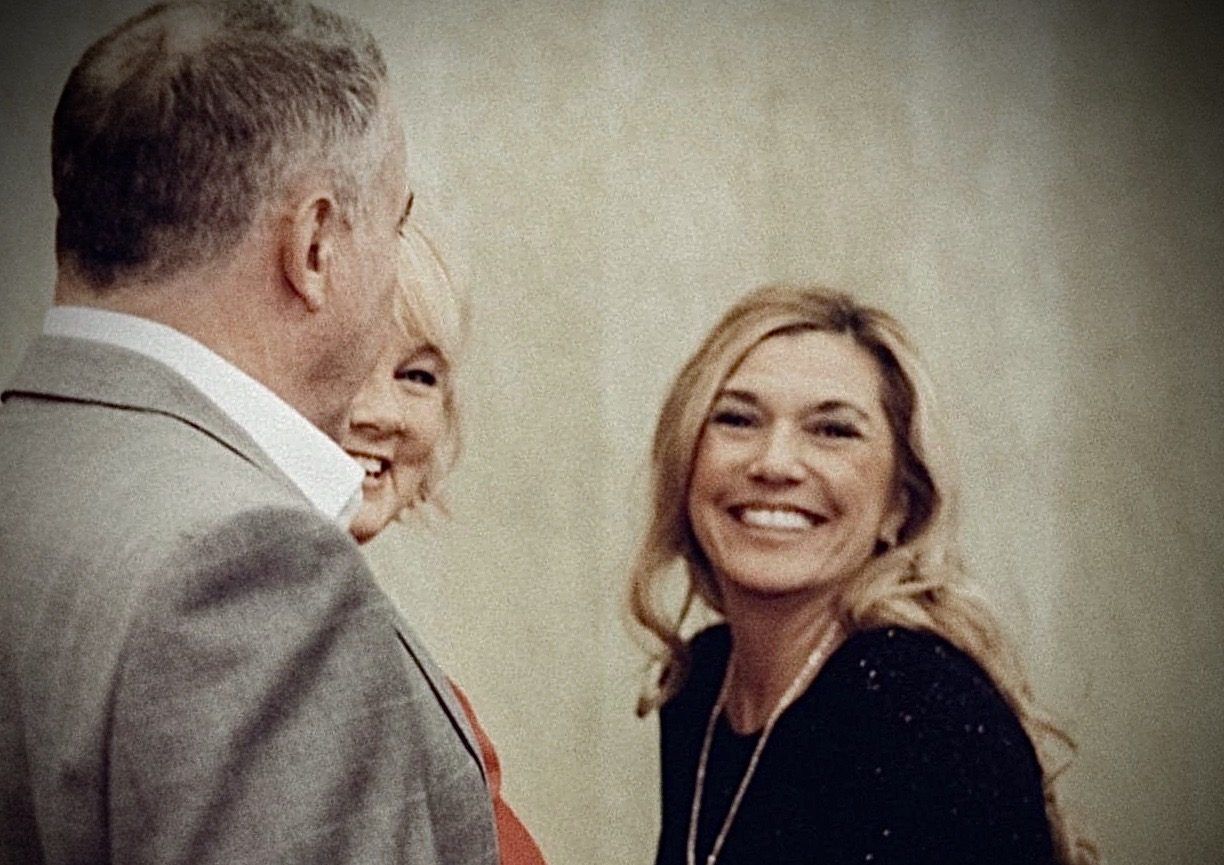 A man and a woman are standing next to each other and smiling.