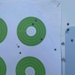 A close up of a target with green circles on it.