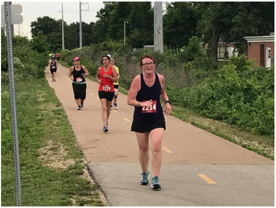 A group of people are running on a path.