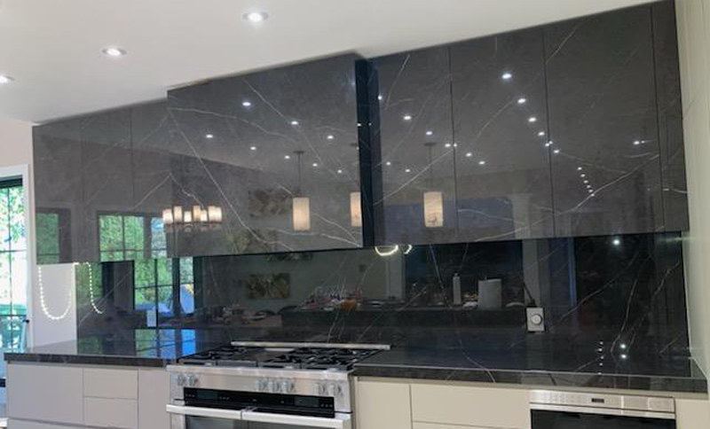 Cabinet doors, hood and high back splash in Liem Dark Polished large format Xtone porcelain