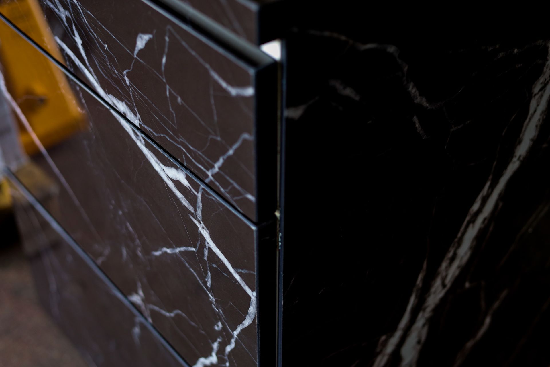 A close up of a black and white custom porcelain cabinet with matching counter top.