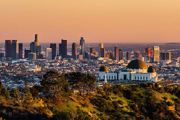 An aerial view of a city skyline with a dome in the foreground.