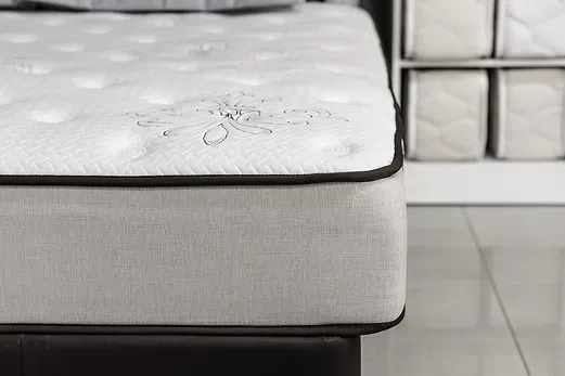 A mattress is sitting on top of a bed in a room.