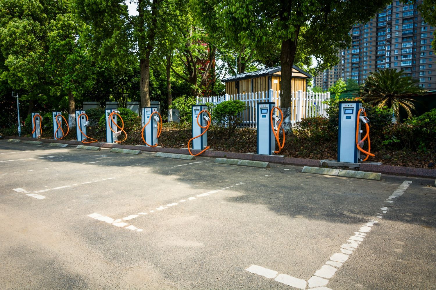 A row of electric vehicle charging stations in a parking lot.