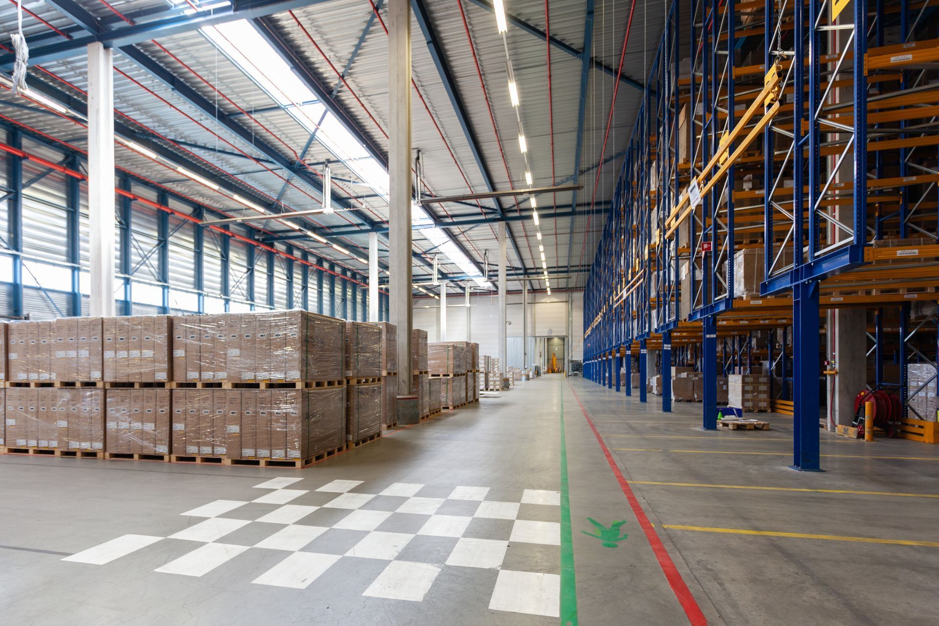 A large warehouse filled with lots of boxes and shelves.