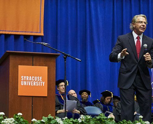 A man is giving a speech at syracuse university