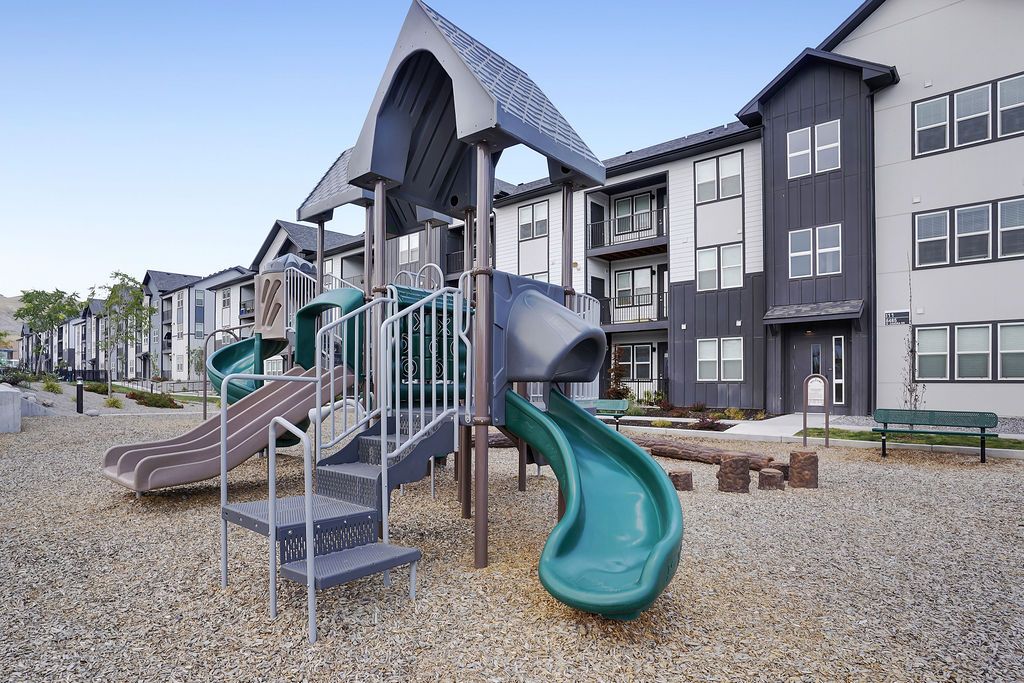 Playground with slides in a modern apartment community courtyard.