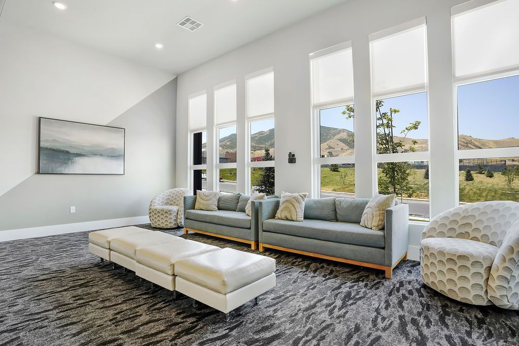 Bright modern resident lounge with large windows and seating.