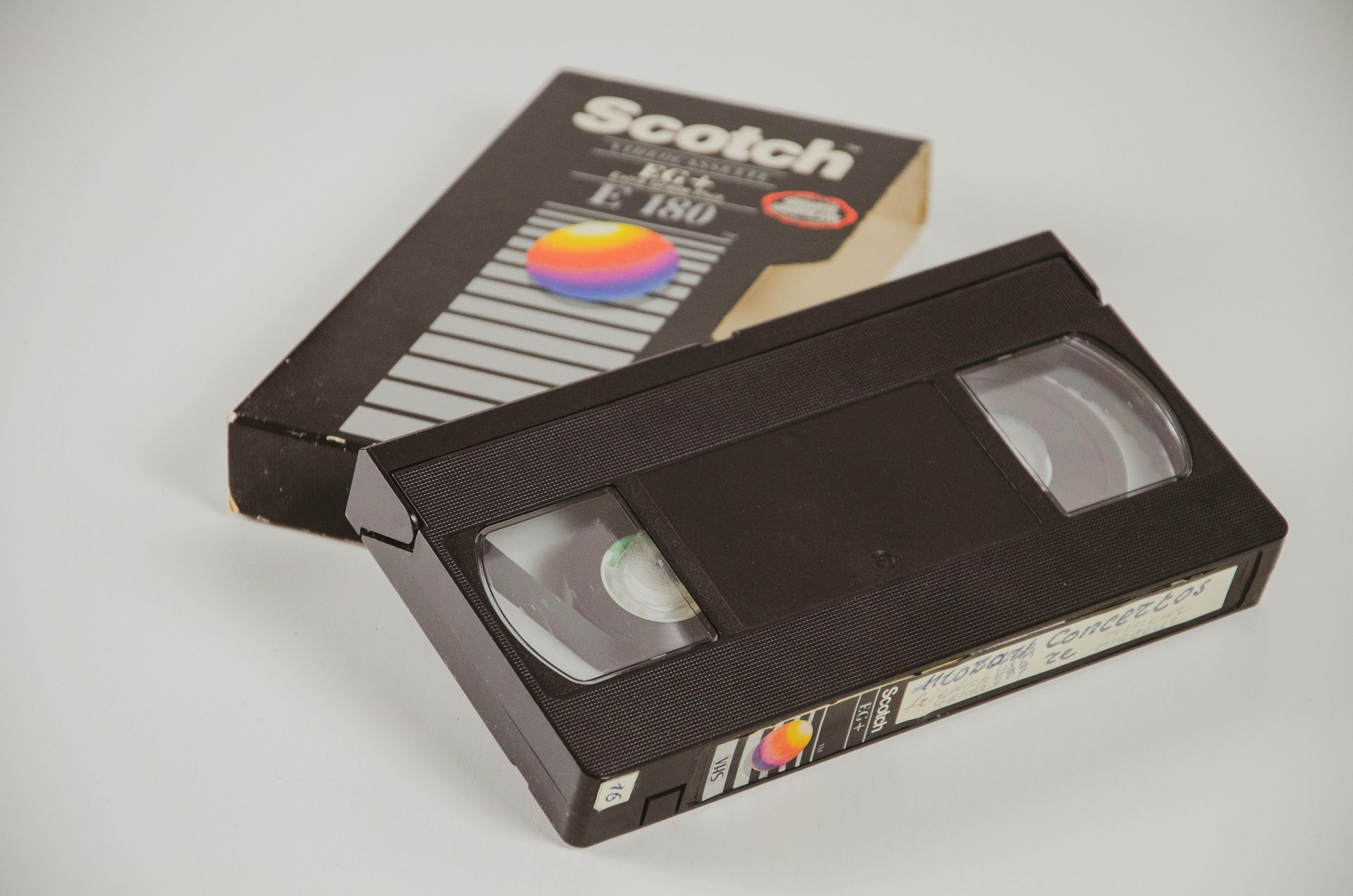 Vintage Scotch VHS tape with black casing and colorful label beside its box