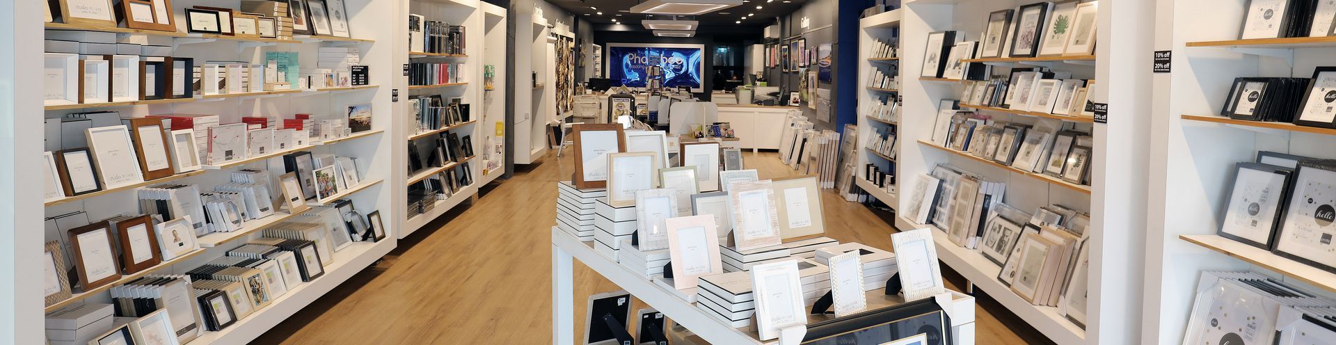 Bright bookstore aisle with shelves of books and magazines and a display table in the center