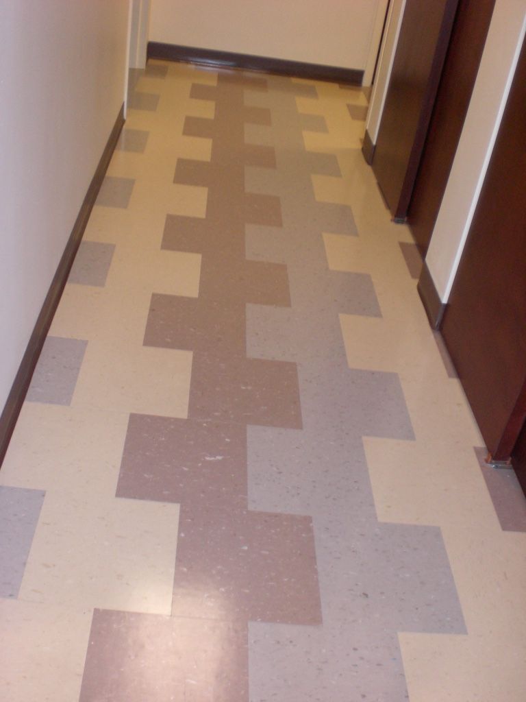Hallway with beige and brown geometric tile flooring.