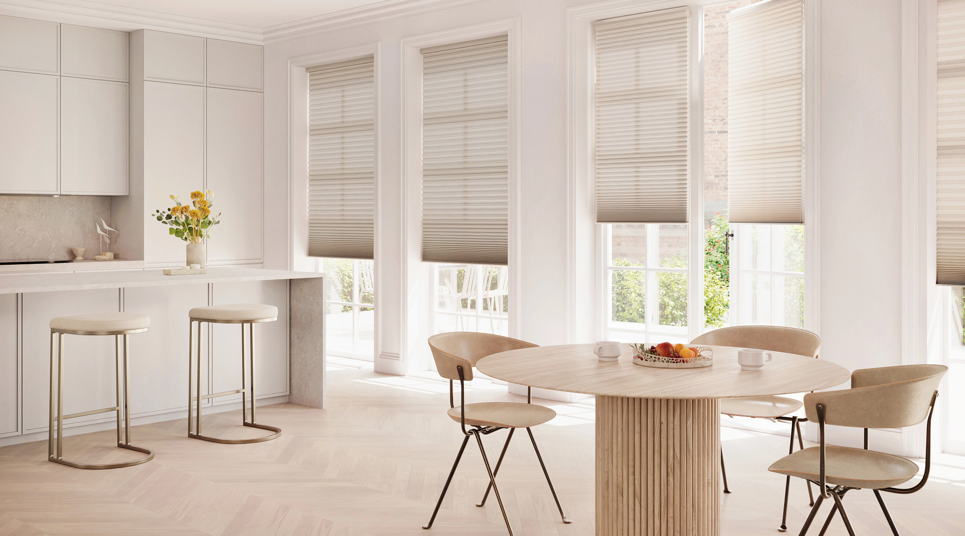 Bright white modern kitchen and dining area with round table, bar stools, and large windows