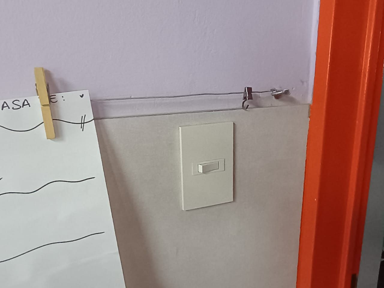 Persona utilizando un destornillador para instalar o reparar la cerradura de una puerta de madera.