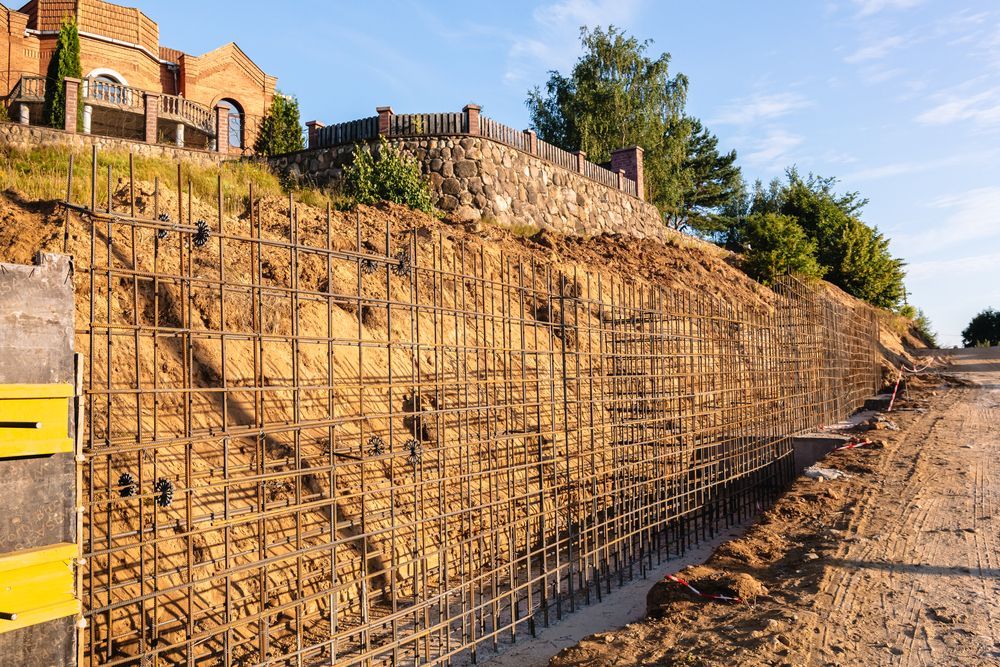 A Red Tractor Sits Near a River Bank — Macca's Dynamic Earthworks in Tolga, QLD
