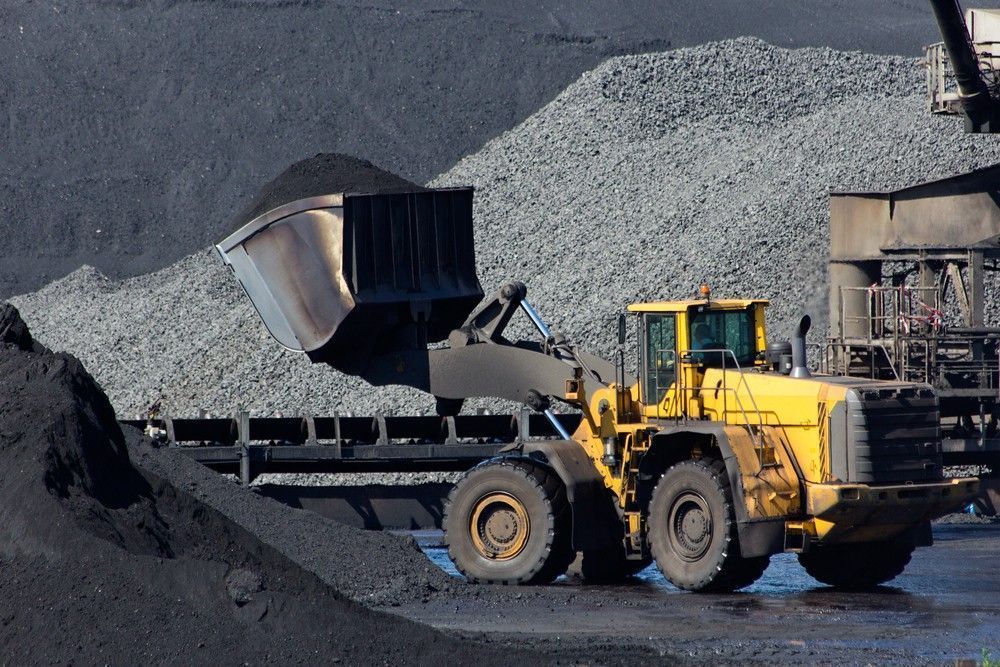Yellow Loader Truck Loading Dark Coal — Macca's Dynamic Earthworks in Tolga, QLD