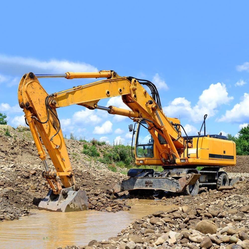 Yellow Excavator Digging in Muddy Water — Macca's Dynamic Earthworks in Tablelands, QLD