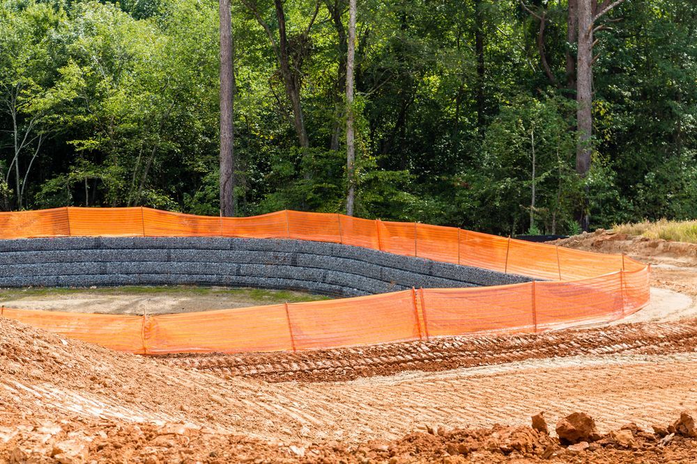 Construction Site With Orange Safety Fencing — Macca's Dynamic Earthworks in Tolga, QLD