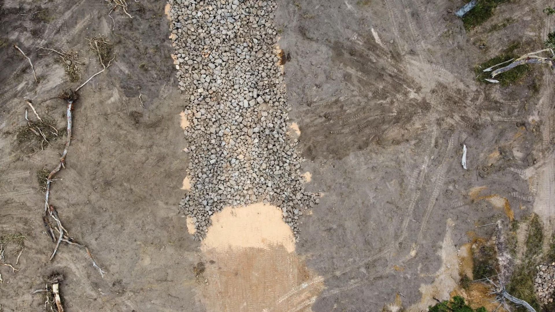 Aerial View of a Deforested Area With a Gravel Path Running Through It — Macca's Dynamic Earthworks in Tolga, QLD